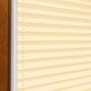 Plissee in Creme, zweiseitig, abdunkelnd, ideal für Fensterdekoration.